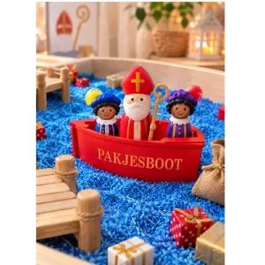 Sint en piet in de houtenpakjesboot in de speelbak met rijst en cadeautjes